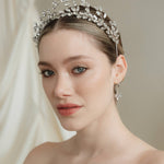Woman wearing a sparkling tiara against a neutral background