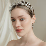 Woman wearing a sparkling tiara against a neutral background