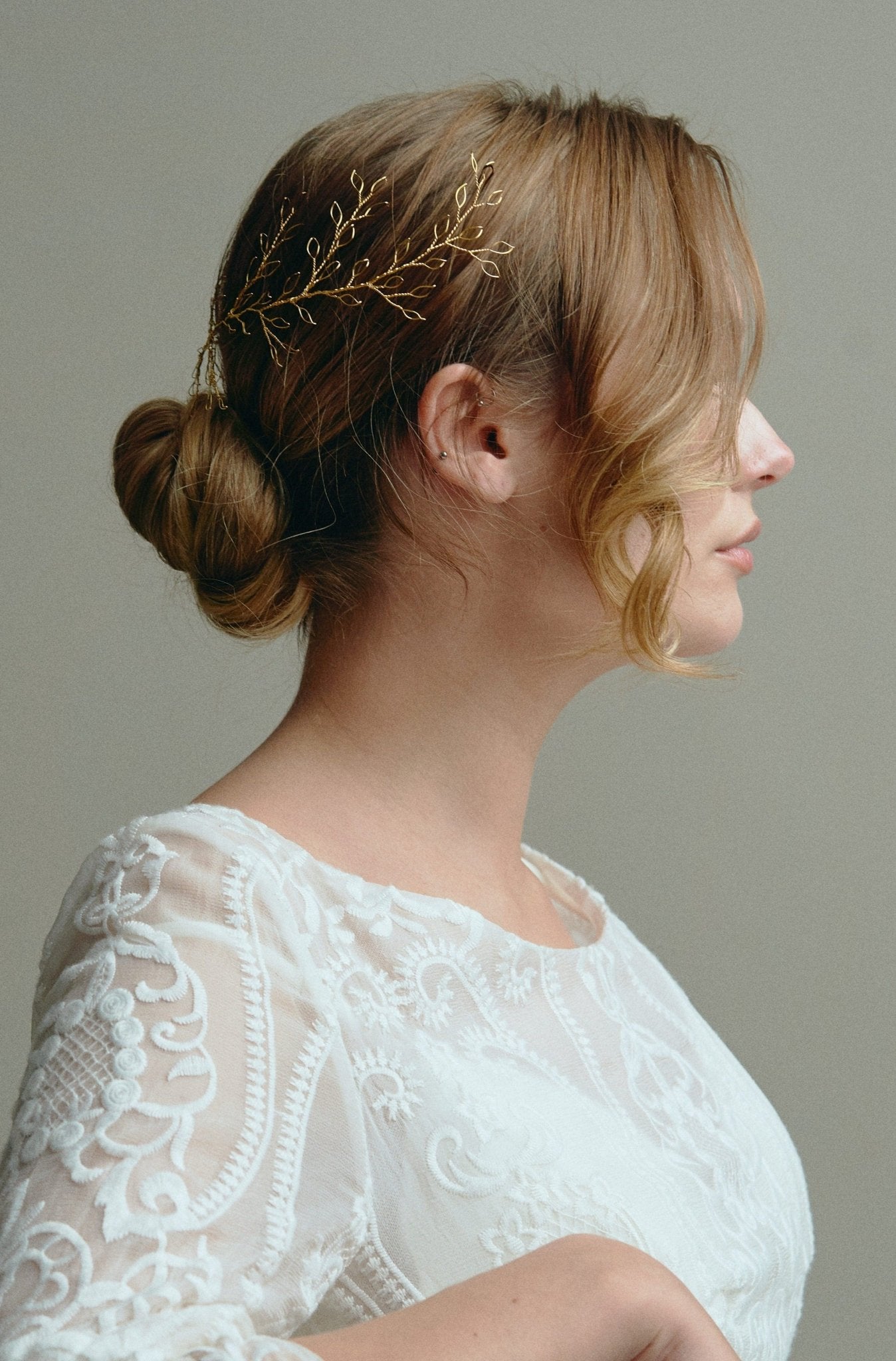 Model wears Large Leafy Hair Vine in gold in the back of her hair above a low bun