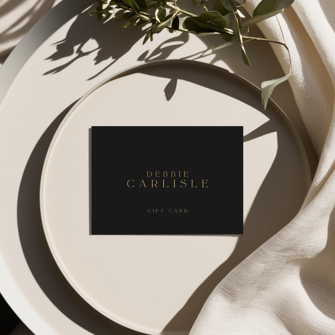gift card image of black postcard with the Debbie Carlisle logo and the words 'gift card' in gold on a beautiful table 