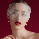 bride wears a sheer chantilly lace mask micro veil with gold hoop vegan baroque pearl earrings and matching necklace