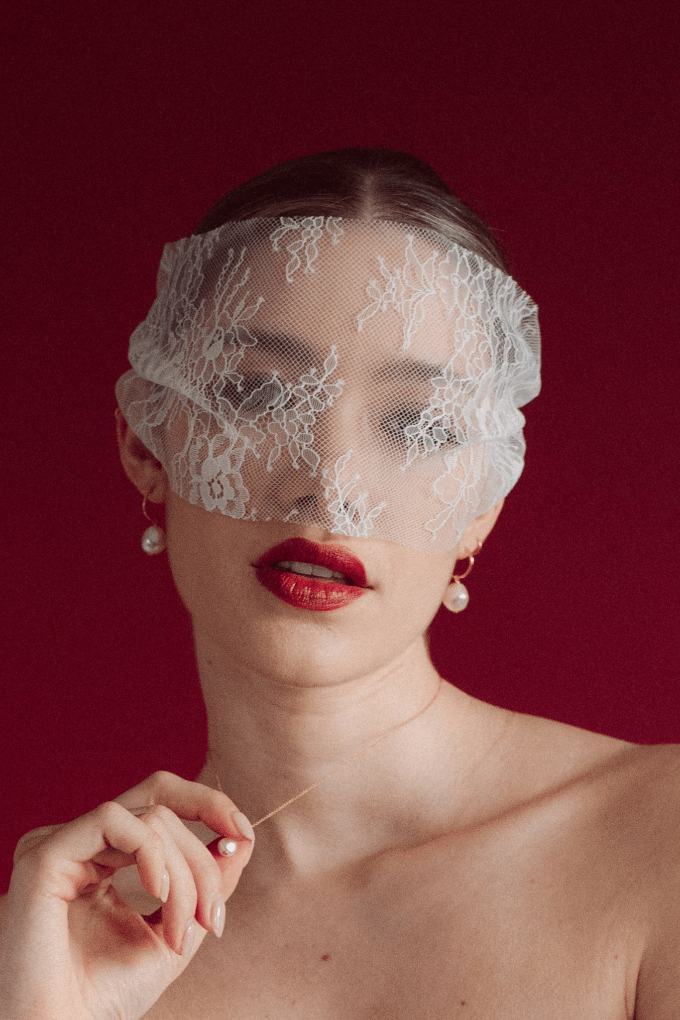 bride wears a sheer chantilly lace mask micro veil with gold hoop vegan baroque pearl earrings and matching necklace