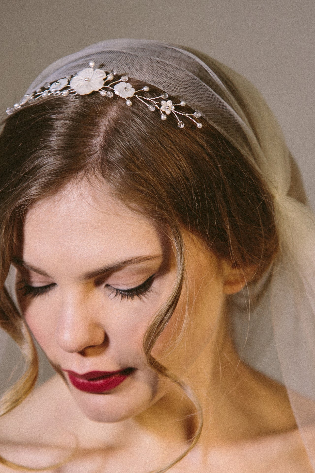 Rustic comb worn in tiara position with ivory flowers with clear crystals and pearls