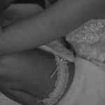 bride wears ivory lace garter with bow