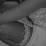 bride wears ivory lace garter with bow