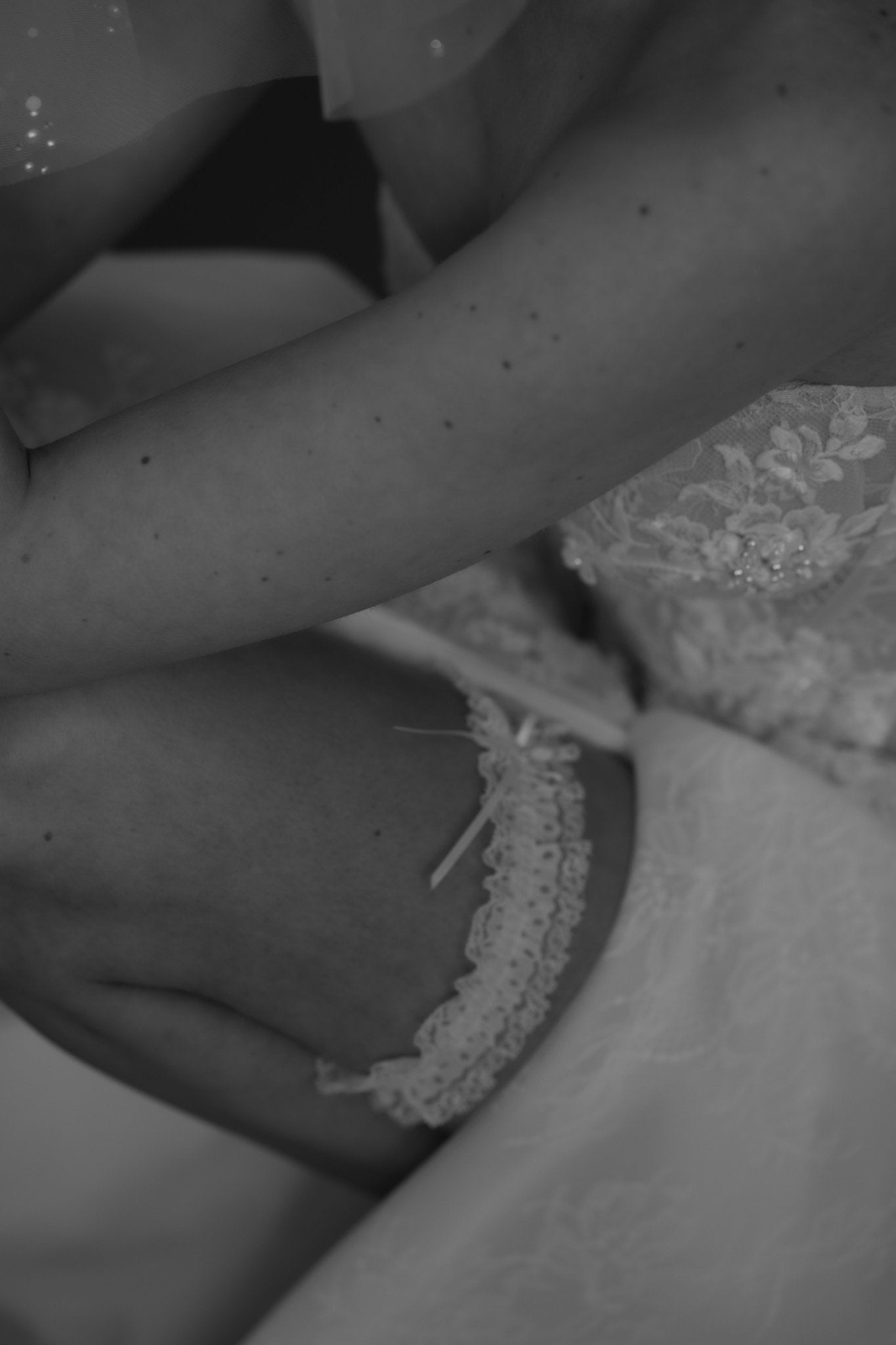 bride wears ivory lace garter with bow