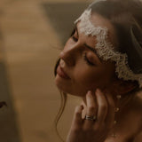 Bride wearing a lace edged tulle short micro veil in Juliet cap veil position