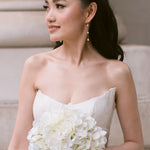 bride wears dainty pearl long drop earrings