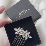 small crystal bridal hair comb being show in gift box and sparkling in the natural light.