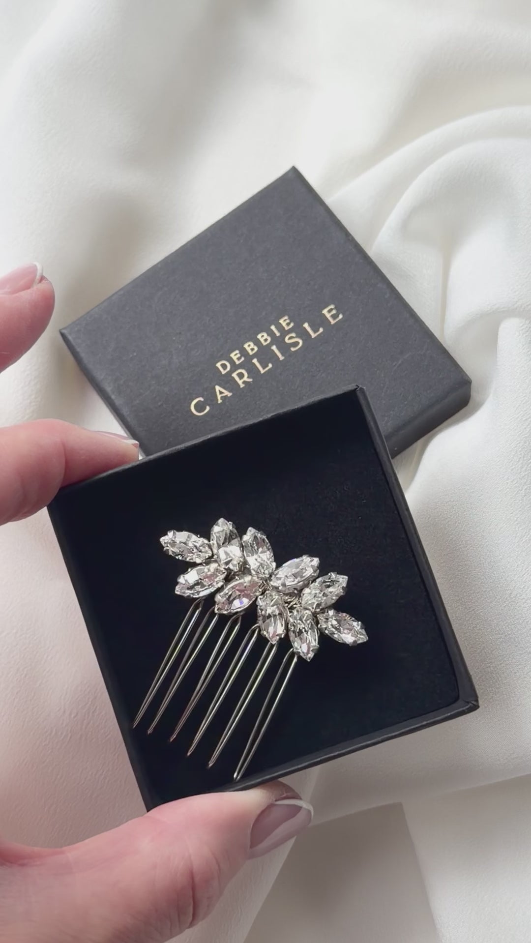 small crystal bridal hair comb being show in gift box and sparkling in the natural light.