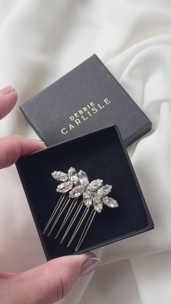 small crystal bridal hair comb being show in gift box and sparkling in the natural light.