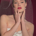 bride wears an oversized blusher style birdcage veil