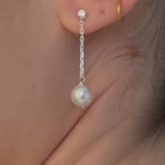 bride wears silver crystal and pearl medium drop earrings