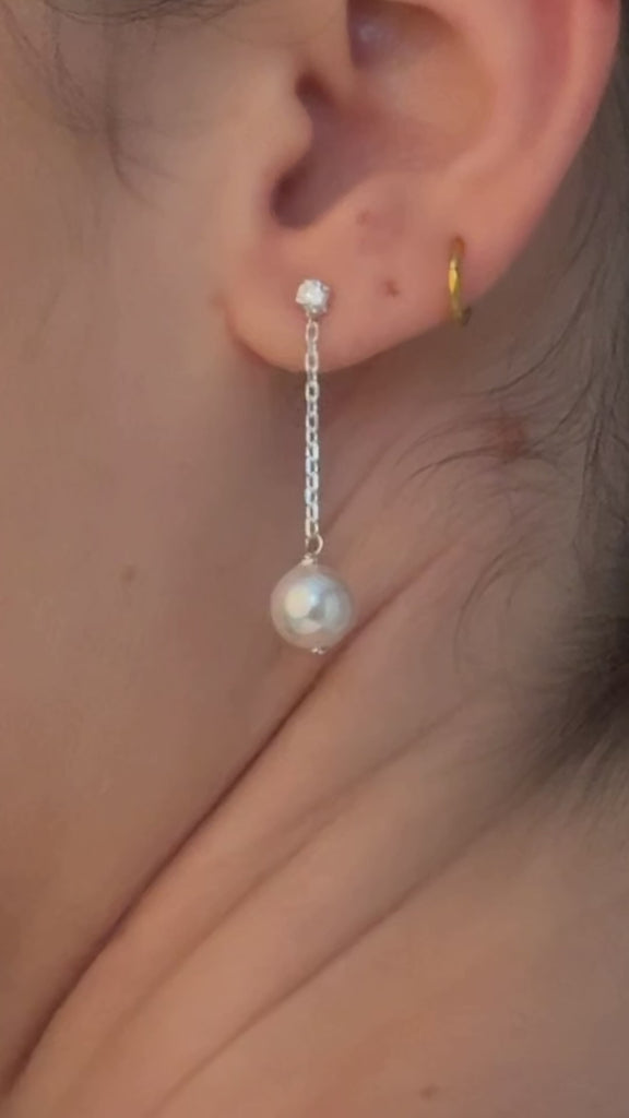 bride wears silver crystal and pearl medium drop earrings