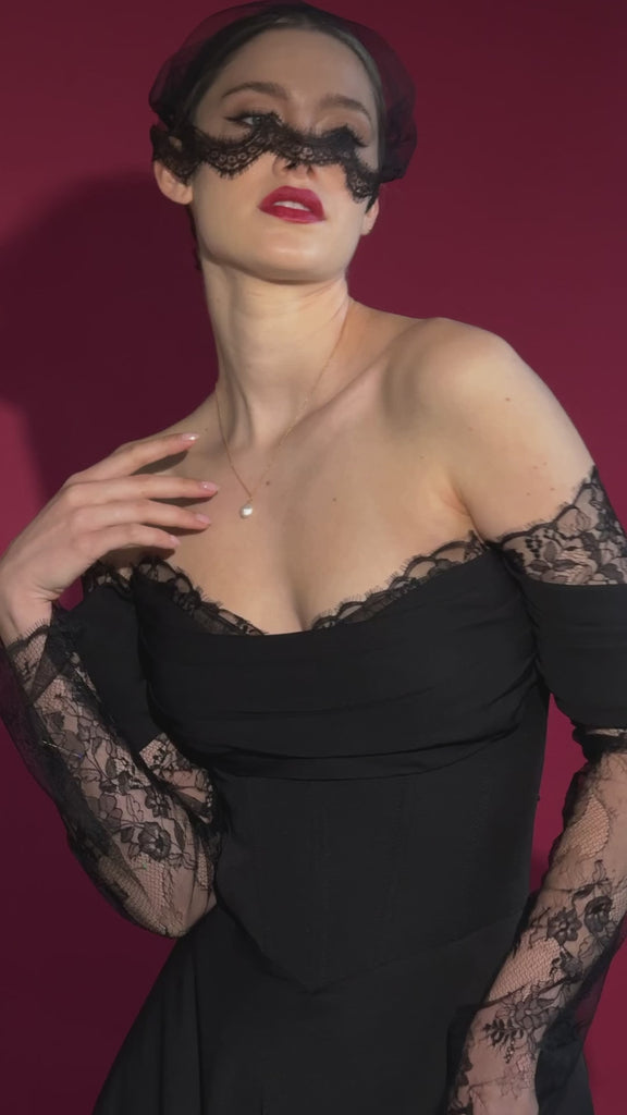 bride wears a black satin and lace dress with a black tulle mask style micro veil with lace edging
