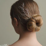 Model wears silver leaf wedding hair vine pair