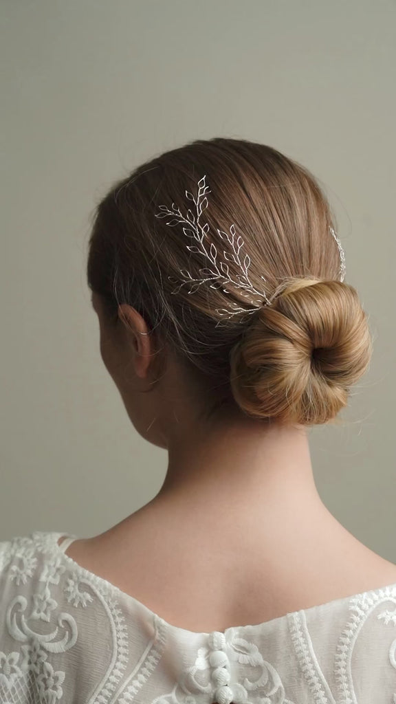 Model wears silver leaf wedding hair vine pair