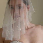 bride wears drop veil in a micro veil short length with crystal and pearl embellishment