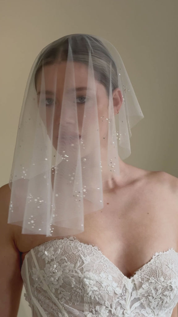 bride wears drop veil in a micro veil short length with crystal and pearl embellishment