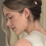 bride wears pearl cluster hair pins with silver crystal and pearl medium drop earrings