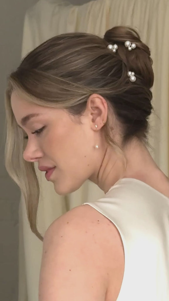 bride wears pearl cluster hair pins with silver crystal and pearl medium drop earrings