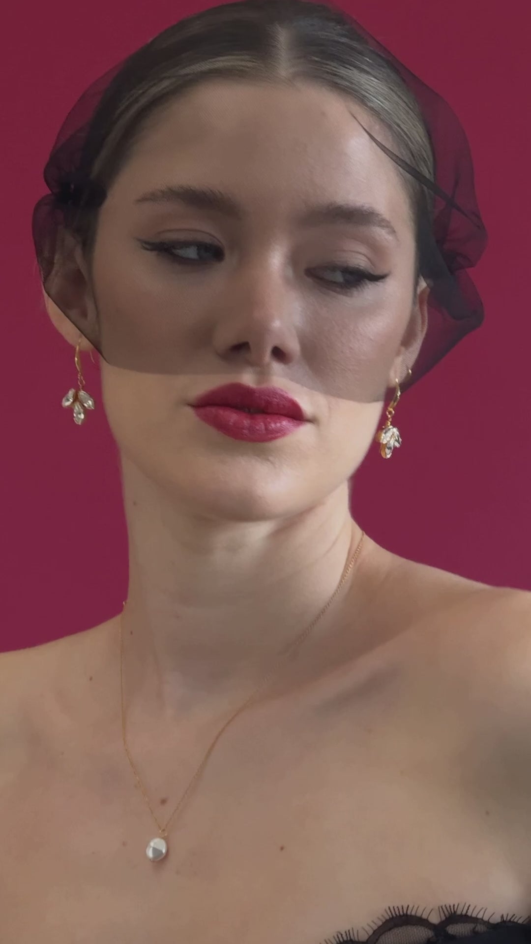 bride wears a black tulle mask style micro veil with gold crystal drop earrings and gold baroque coin necklace