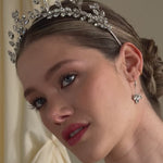 bride wears a silver crystal crown with matching crystal drop earrings