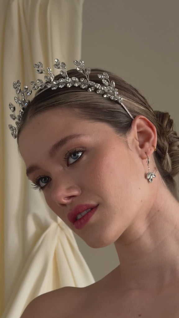 bride wears a silver crystal crown with matching crystal drop earrings