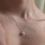 bride wears vegan coin pearl necklace