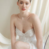 a bride wears a set of two stacked silver crystal crowns with matching hair pins extending over the top of her head s if growing from the tiara style base.