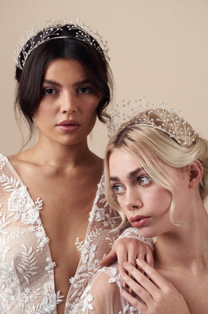 Two models show different ways to wear the Maeve crowns - in pearl and clear crystal designs