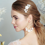 Silver mother of pearl flower comb and matching bridal earrings worn with low ponytail