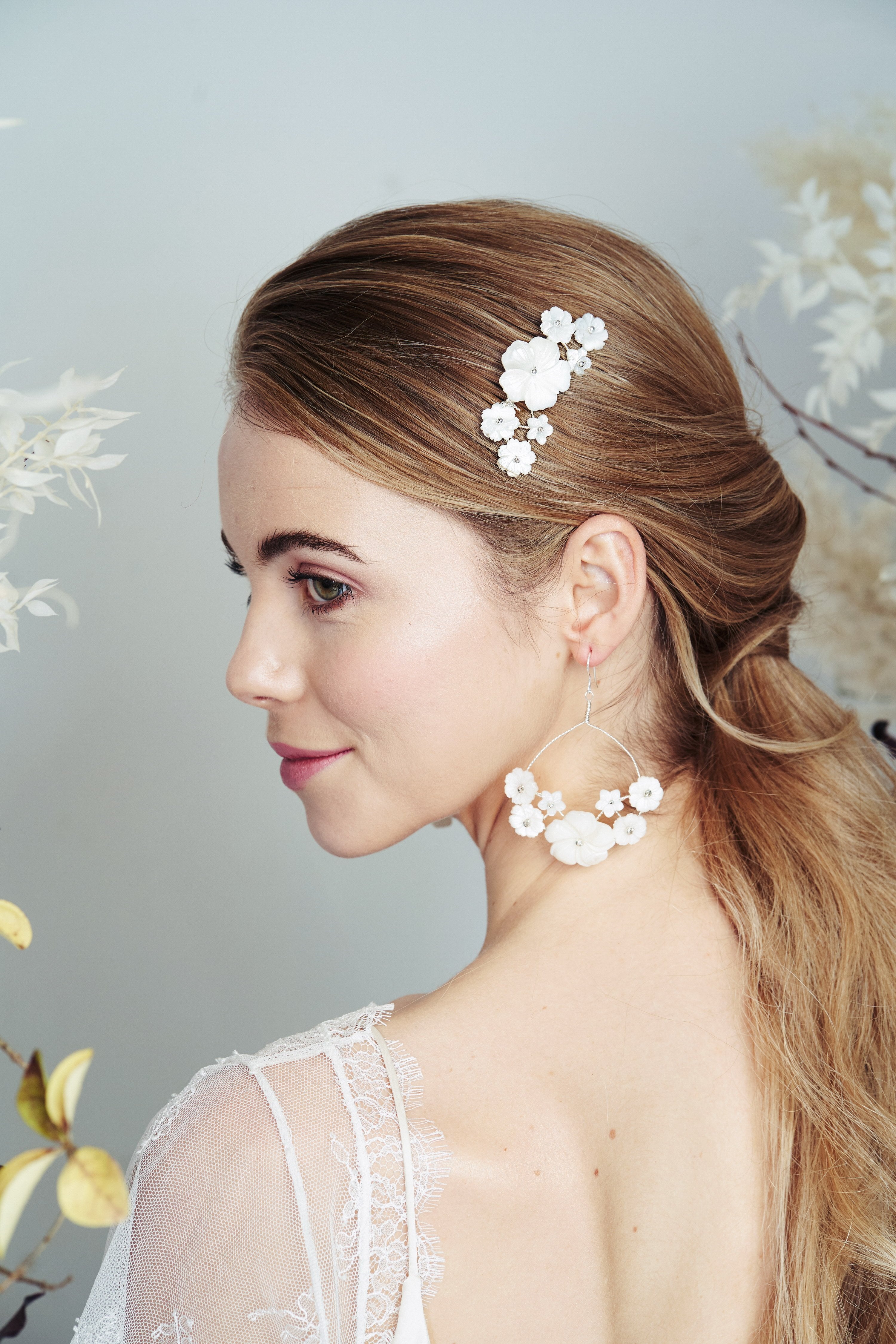 Silver mother of pearl flower comb and matching bridal earrings worn with low ponytail