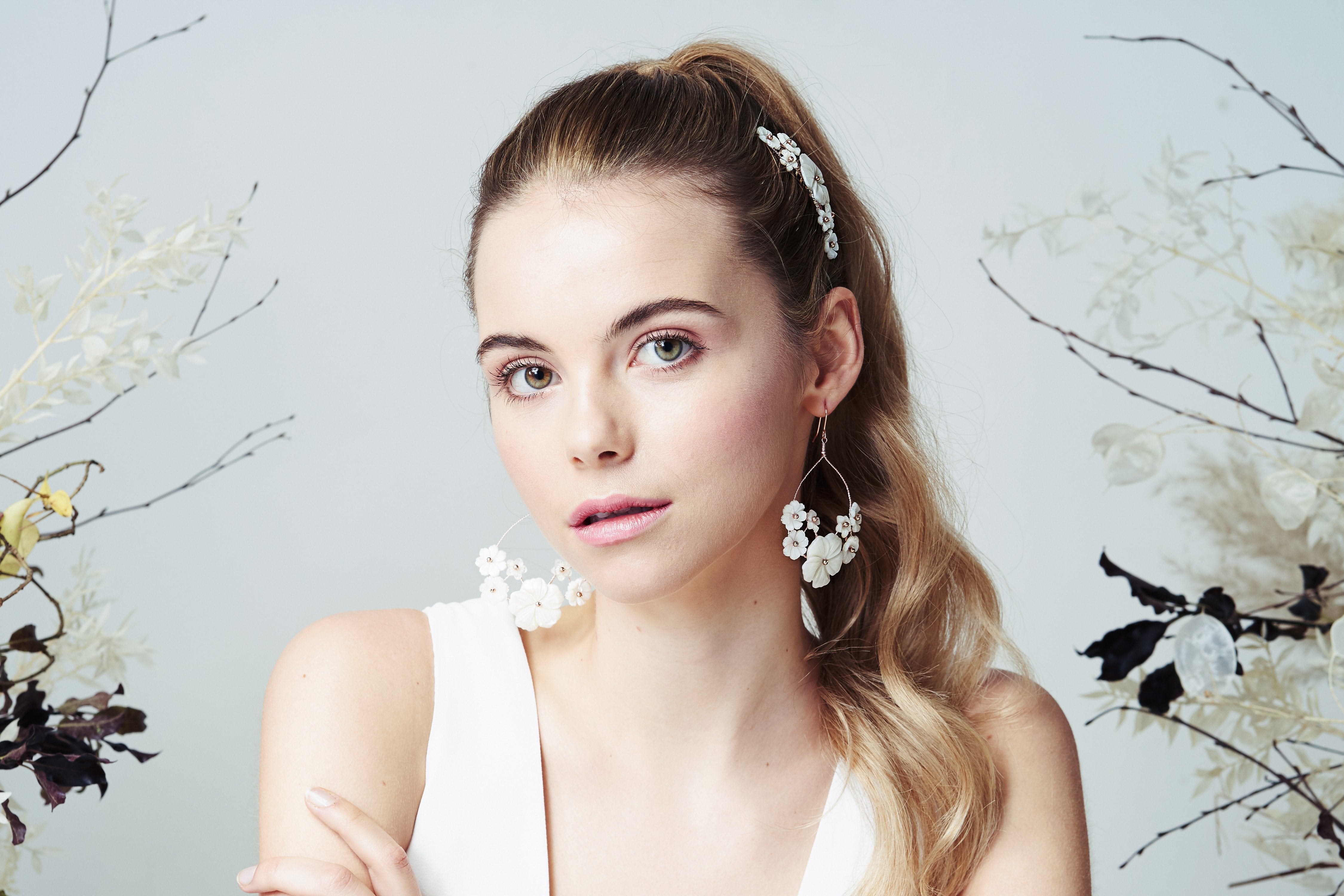 Flower hoop earrings and comb set for a boho bride worn with high pony tail