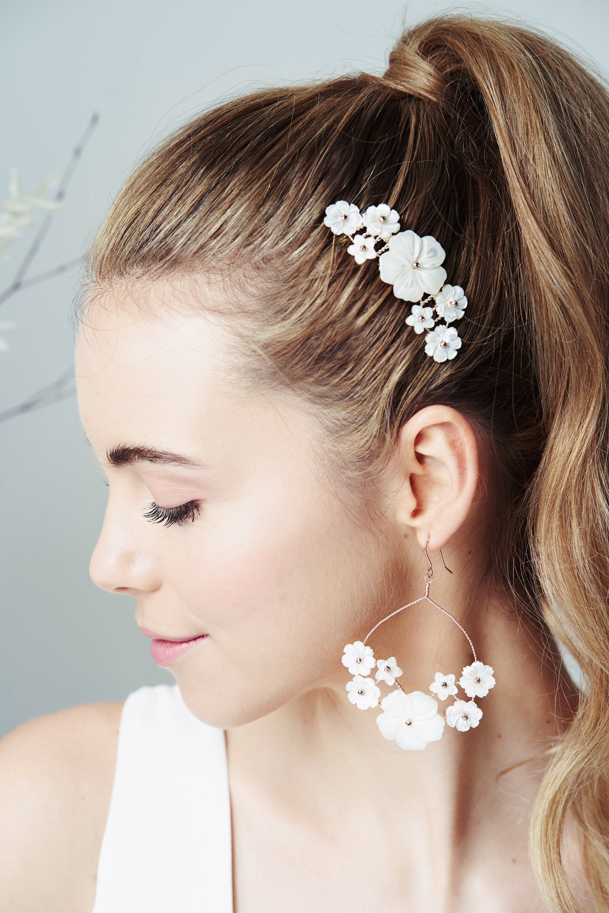 Beth mother of pearl flower comb by Debbie Carlisle worn with sleek high ponytail