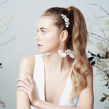 Statement bridal earrings with pearl flowers and matching wedding hair comb