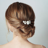 Mother of pearl flower wedding hair comb worn with relaxed updo