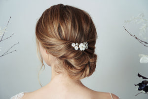 Mother of pearl flower wedding hair comb worn with relaxed updo