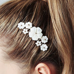 Beth mother of pearl flower comb by Debbie Carlisle worn with sleek high ponytail