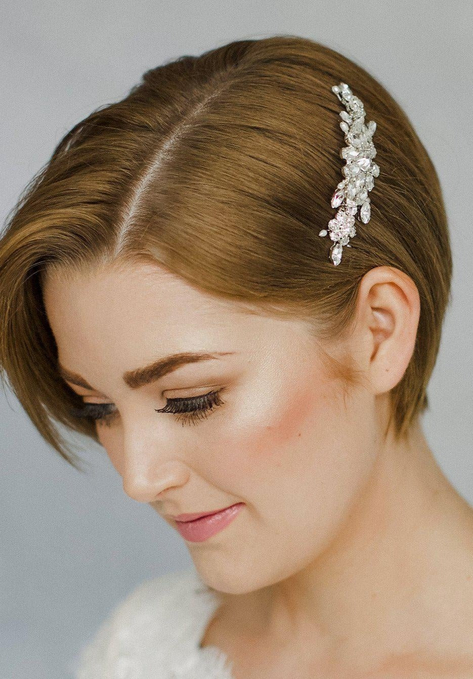 Short haired bride with pixie cut wears a vintage crystal wedding hair comb