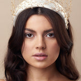 Embellished floral ivory padded headband worn with gold crystal crown