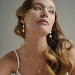 Model wears silver statement  vegan pearl drop earrings with matching vegan baroque pearl necklace