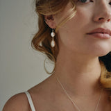 Model wears silver statement  vegan pearl drop earrings with matching vegan baroque pearl necklace