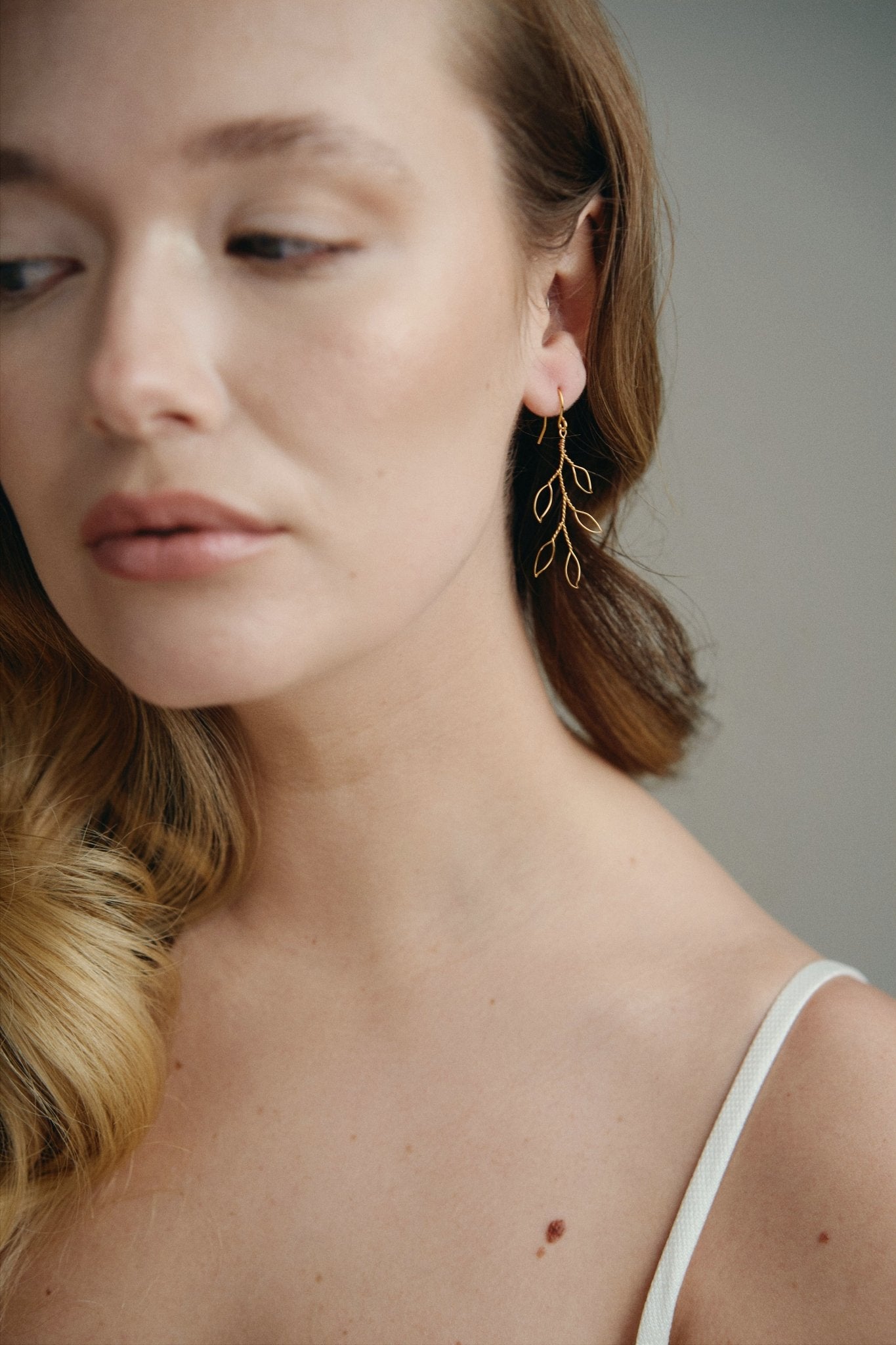 delicate gold wire leaf design earrings