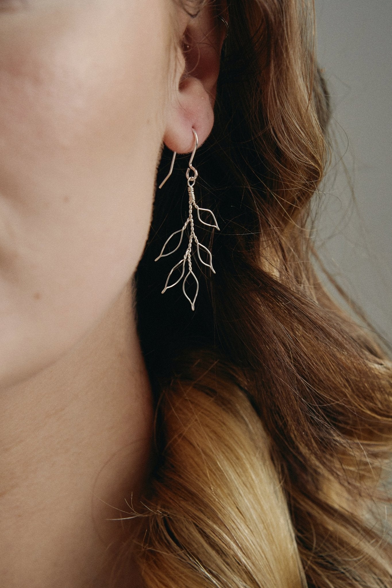 delicate silver wire leaf design earrings