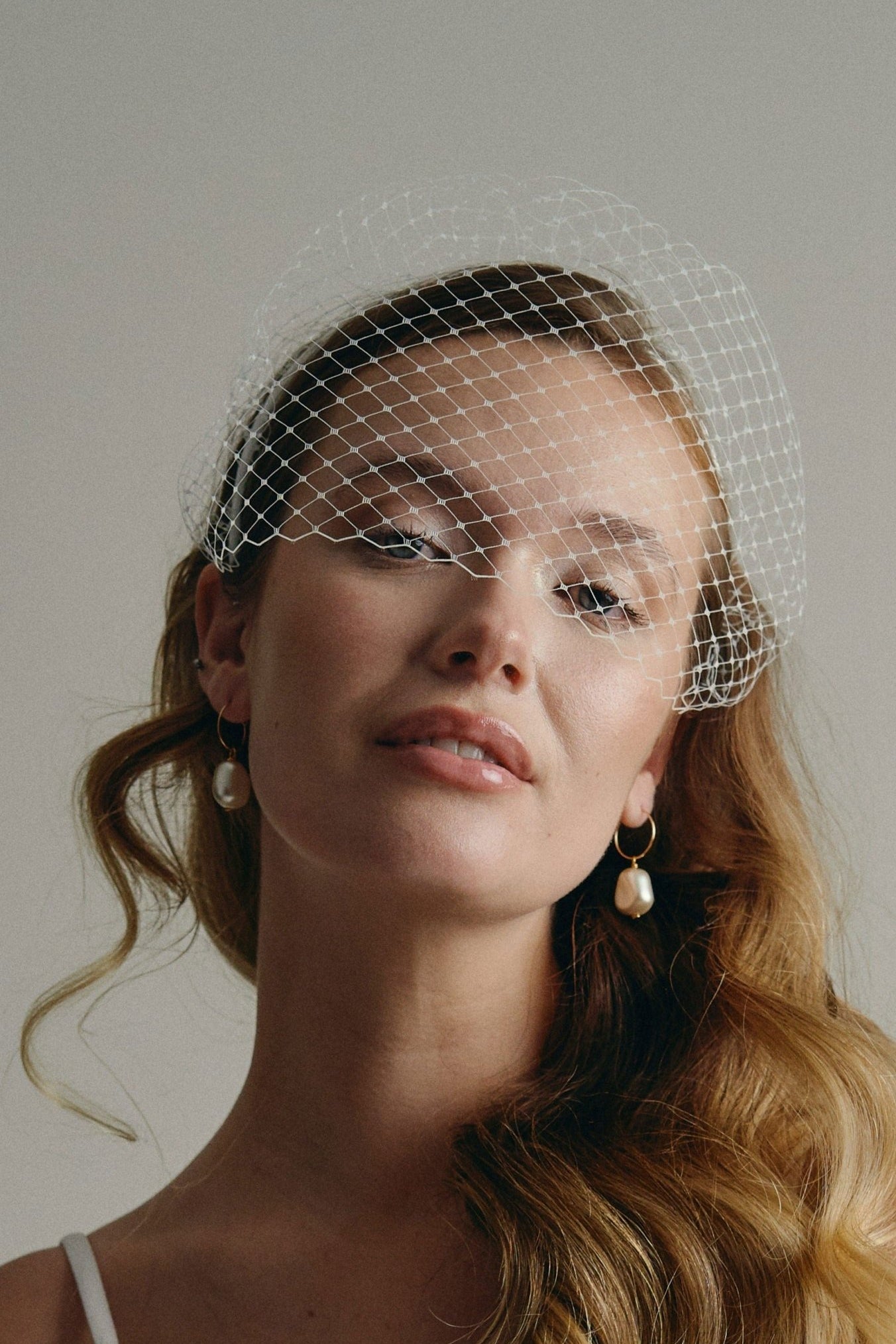 Eliza large baroque pearl hoop earrings with Raye birdcage veil headband